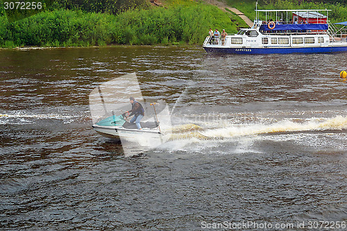 Image of The man on a hydrocycle floats down the river.