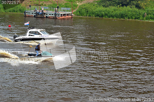Image of The man on a hydrocycle floats down the river.