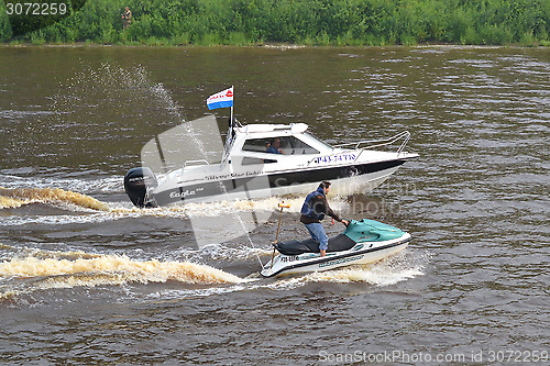 Image of The man on a hydrocycle floats down the river.