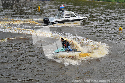 Image of The man on a hydrocycle floats down the river.