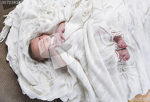 Image of infant with blanket in bed