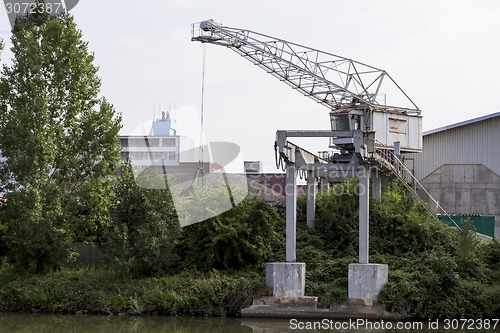 Image of small dockside crane at river in germany