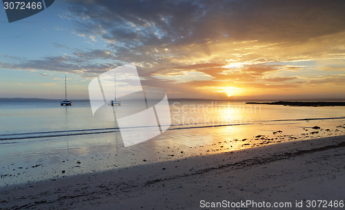 Image of Catamarans on the water at sunset