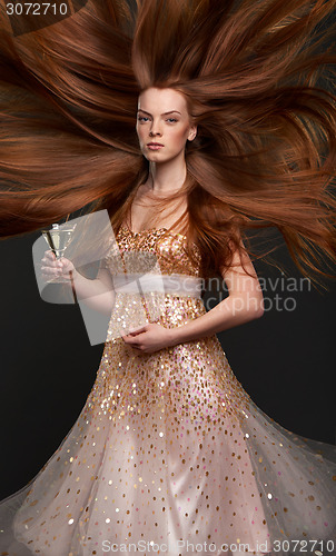 Image of Redheaded woman with glass of cocktail