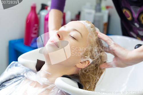 Image of Hairdresser salon. Woman during hair wash. 