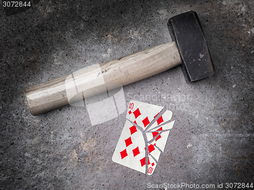 Image of Hammer with a broken card, ten of diamonds