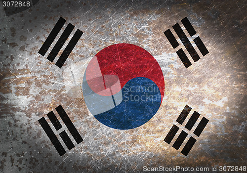 Image of Old rusty metal sign with a flag