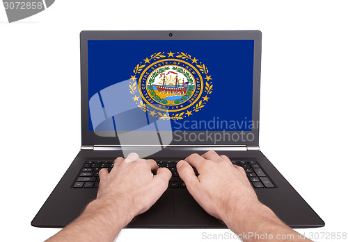 Image of Hands working on laptop, New Hampshire