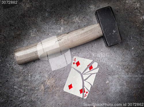 Image of Hammer with a broken card, four of diamonds