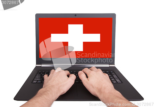 Image of Hands working on laptop, Switzerland