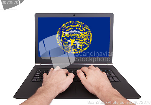 Image of Hands working on laptop, Nebraska