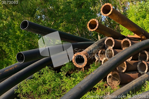 Image of Rusty metal pipes in the forest