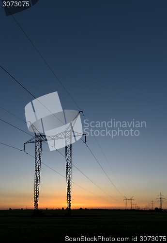 Image of Large transmission towers at sunset