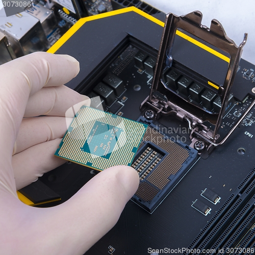 Image of Human hand holding modern processor