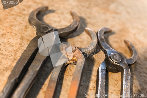 Image of Old tools on rusty steel