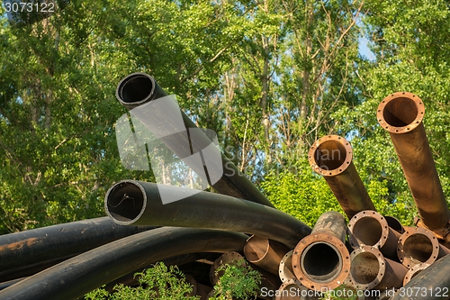 Image of Rusty metal pipes in the forest