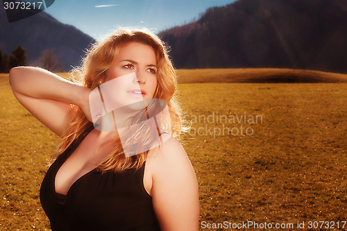 Image of Portrait of a beautiful blonde woman with luscious cleavage