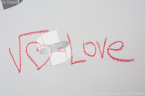 Image of Square root of heart on white paper. Handwritten love formula. 