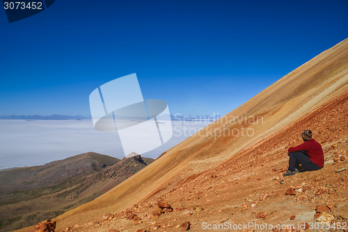 Image of Hiker on colored mountain