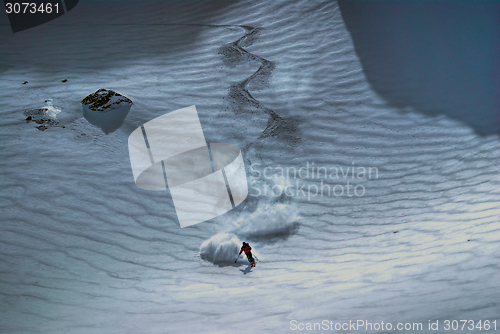 Image of Male skier riding down the hill