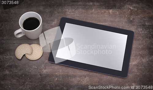 Image of Tablet touch computer gadget on wooden table