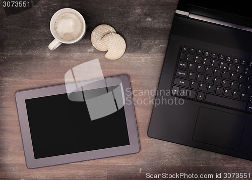 Image of Tablet touch computer gadget on wooden table