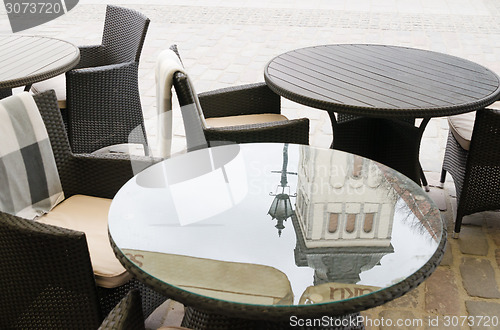 Image of Reflection of the church spire on the surface of a table in a ca