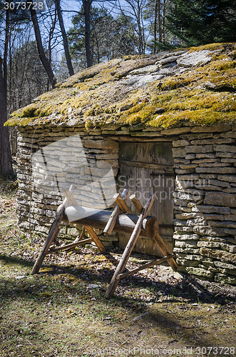 Image of Old rural building with a roof covered by straw, close-up