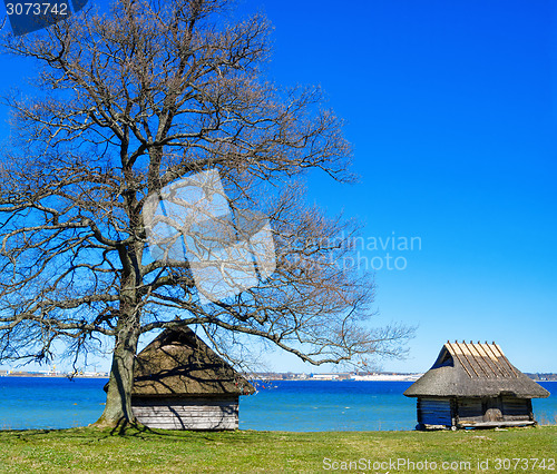 Image of Old rural building with a roof covered by straw, close-up