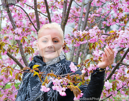 Image of Portrait of a woman with sakura flowers