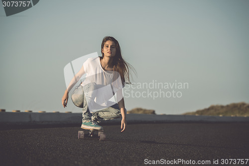 Image of Skater girl making dowhill