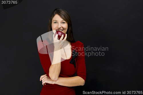 Image of Young woman eating an apple