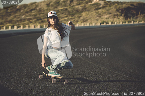 Image of Skater girl making dowhill