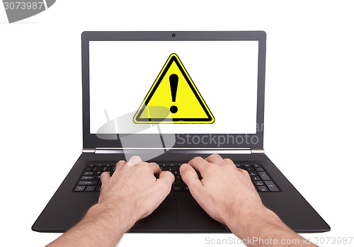 Image of Man working on laptop, danger