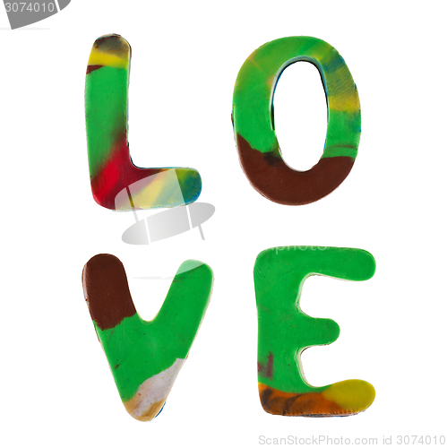 Image of Plasticine letters forming word LOVE written on white background