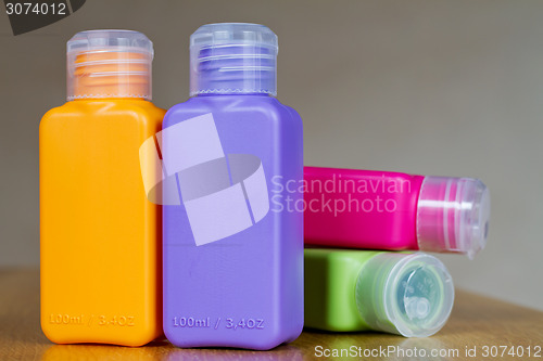 Image of Small colored plastic bottles for traveling