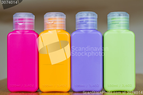 Image of Small colored plastic bottles for traveling