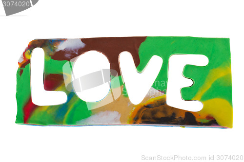 Image of Plasticine letters forming word LOVE written on white background