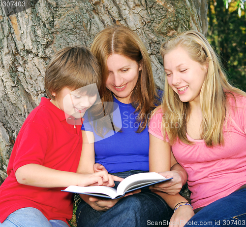 Image of Family reading a book