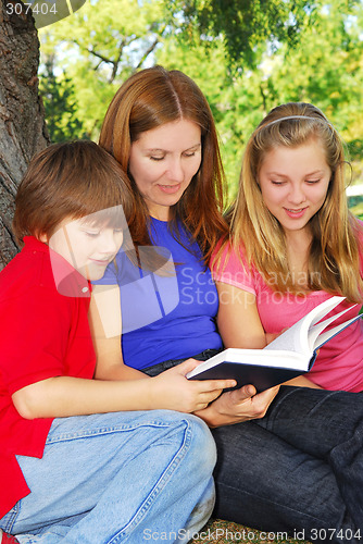Image of Family reading a book