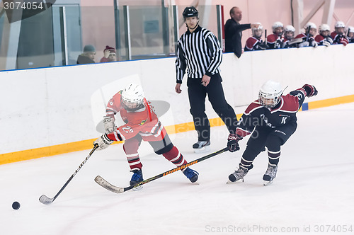 Image of Game moment of children ice-hockey teams