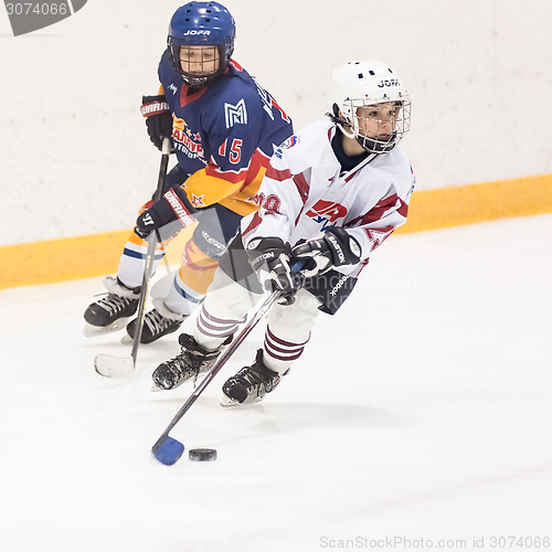 Image of Play moment between children ice-hockey teams