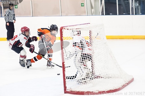 Image of Attack in game between children ice-hockey teams