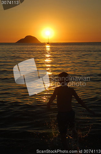 Image of Kid playing on sunset on Itaipu Beach