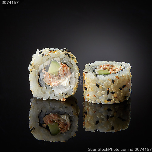 Image of sushi with salmon and cucumber