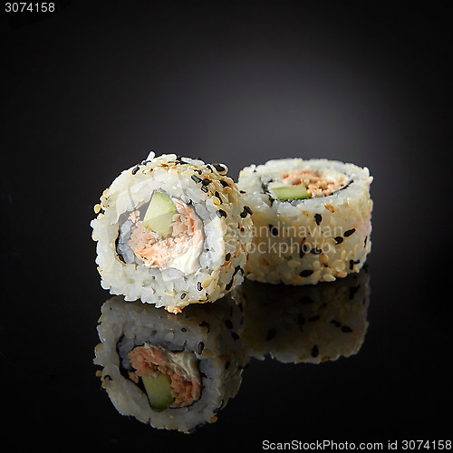 Image of sushi with salmon and cucumber