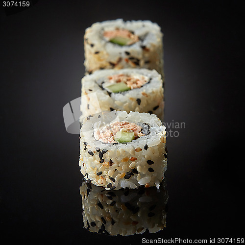 Image of sushi with salmon and cucumber