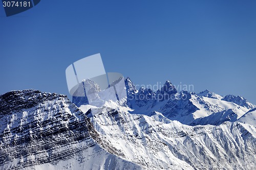 Image of Snowy rocks at sun day