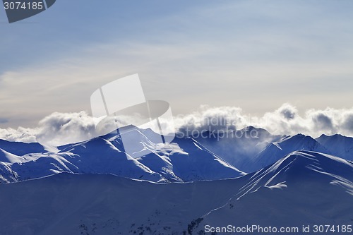 Image of Evening winter mountains and sunlight clouds