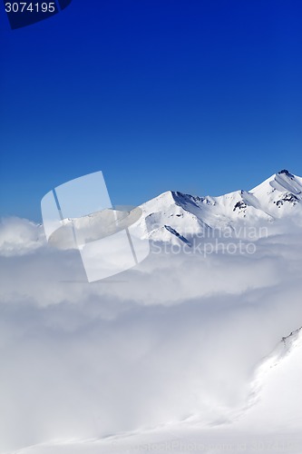 Image of Mountains in clouds at nice winter day